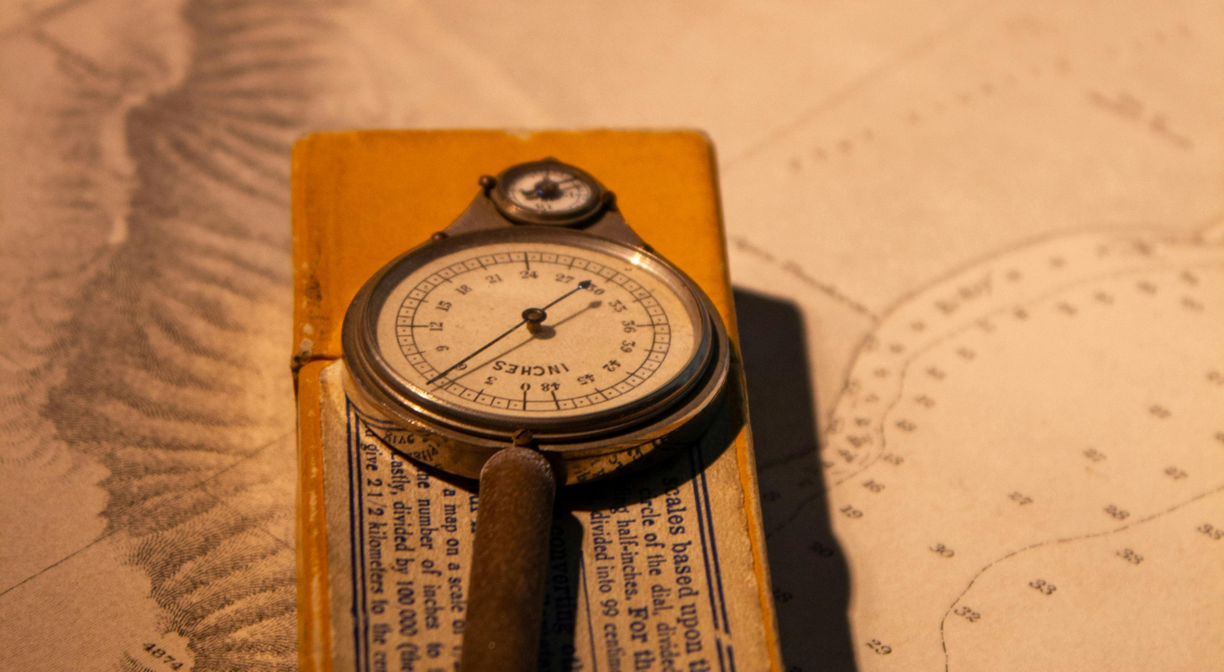 A close-up of a vintage map measuring tool.